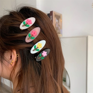 Dettaglio di 4 pezzi di mollette per capelli con fiori 3D in rilievo su una modella