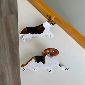 Detailed view of Beagle and Corgi dog shaped acetate hair claws in tricolor finish