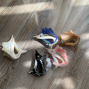 Detailed macro view of acetate swordfish hair claws in five different marble patterns