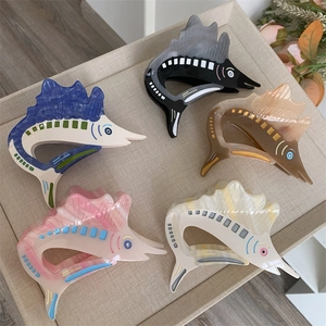 Creative acetate sailfish hair claws set in various colors on a textured tray