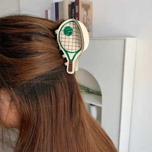 Detail of tennis racket acetate hair claw clip worn on hair with minimalist home background