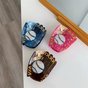 Three acetate baseball glove hair claws in navy, pink, and tortoiseshell shown from top view
