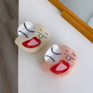 Detail of unique acetate baseball hair claws in cream yellow and pink marble textures