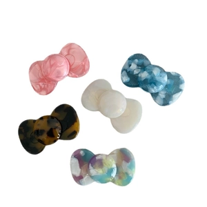 Candy colored acetate bow hair clips in marble and floral patterns for women and girls