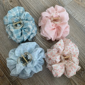 Detailed set of four floral chiffon hair claw clips with various pastel patterns