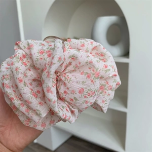 Floral chiffon hair scrunchie in light pink fabric with elegant ruffles for women