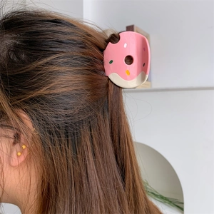 Chic pink donut-shaped hair claw clip with colorful sprinkles for women’s long hair styles