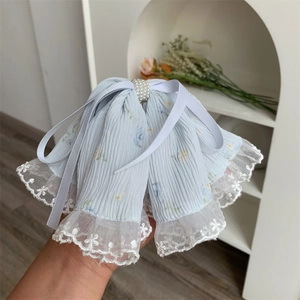 Close-up of blue chiffon hair claw clip with white lace trim and pearl ribbon detail