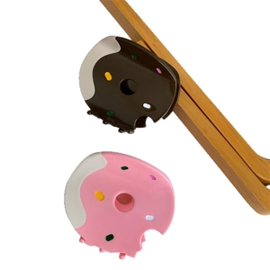 Sweet donut-shaped hair claw clips set in chocolate and pink with colorful sprinkles