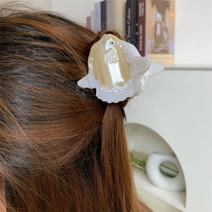 Ocean series sunfish hair claw clip made of acetic acid shown styling brown long hair