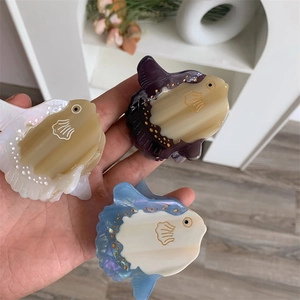 Detailed view of three ocean sunfish hair claws made of high-quality acetate in multiple colors