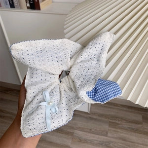 Close-up of eyelet lace hair scrunchie with blue gingham trim and pearl bow detail