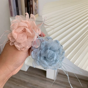 Elegant handmade fabric flower hair tie with soft feathers and spiral telephone wire band