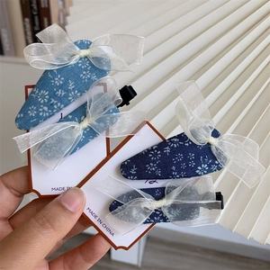 Floral cotton hair clips set with white organza bows in navy and light blue