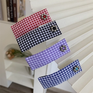 Set of 4 checkered fabric hair clips with small metal flower accents in multiple colors