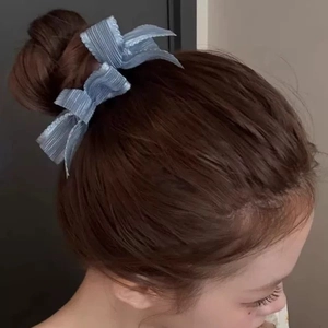 Blue multilayer bow scrunchie for buns made of shimmering fabric with wavy edges
