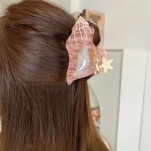 Pink conch shell hair claw with starfish detail for elegant beach hairstyles