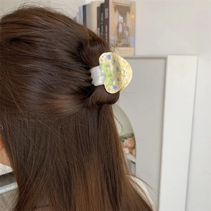 Polka dot acetate mushroom hair claw clip on brunette hair for a sweet style