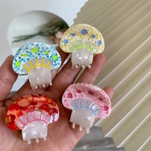Detail showing colorful mushroom hair claws with pearl texture in four vibrant colors