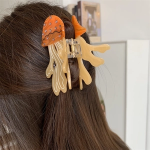 Detail of mushroom jelly fish hair claw clip with rhinestones worn on hair