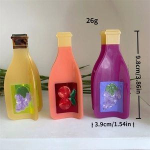 Detailed view of creative wine bottle hair claws with grape and cherry relief patterns