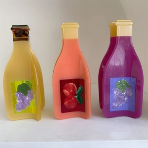 Macro detail of acetate juice bottle hair claws with embossed fruit patterns