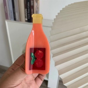 Close-up of acetic acid hair claw in juice bottle shape with cute cherry pattern