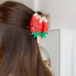 Cute strawberry ice cream shaped acetate hair claw clip worn on long brown hair