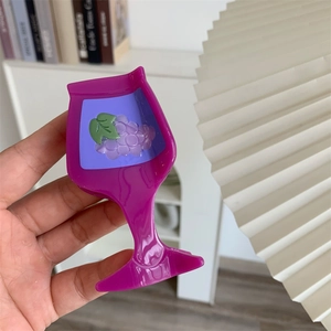 Detailed close-up of a purple goblet shaped acetate hair claw with grape pattern