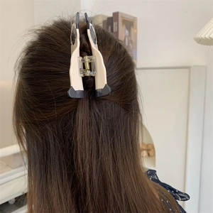 Medium acetate cat hair claw clip shown styling a brown half-up hairstyle