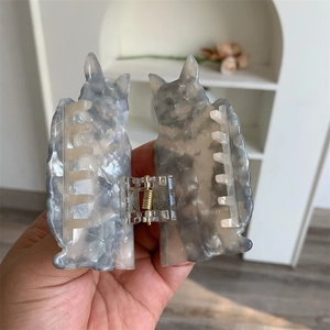 Detail of creative acetate cat hair claw clip with marble texture and sturdy gold spring