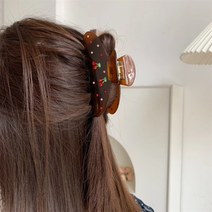 Elegant translucent cherry claw clip with rhinestones for securing long hair