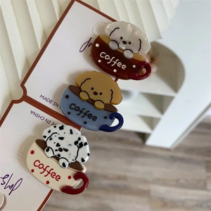 Detailed close-up of cute dog coffee cup acetate hair clips in three colors for women