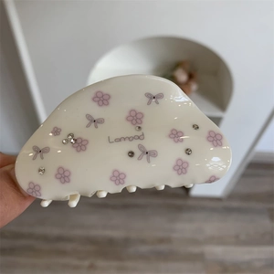 Pince à cheveux florale avec nœuds roses et strass en résine crème translucide
