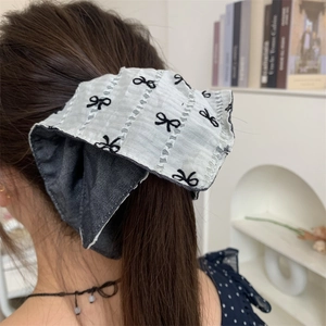 Vintage oversized bow hair scrunchie with white embroidery and denim lining on ponytail