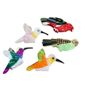 Set of colorful acetate hummingbird and parrot hair claws with marble texture