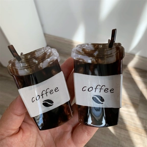 Detailed view of creative coffee cup shaped acrylic hair claws with marble texture