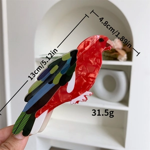 Pince à cheveux perroquet colorée en acétate rouge avec ailes et texture marbre