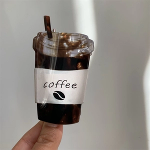 Detail shot of a creative acrylic coffee cup hair claw clip with turtle shell brown texture
