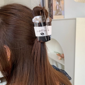 Creative acrylic coffee cup hair claw clip shown on long hair for stylish styling