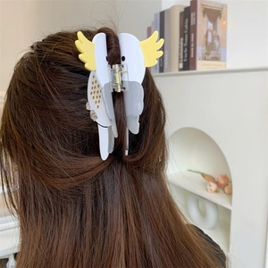 Detail showing high-quality acetate parrot hair claw clip worn in a creative half-up hairstyle
