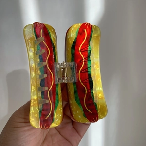 Detailed macro shot of creative hot dog shaped acrylic hair claw clip accessory