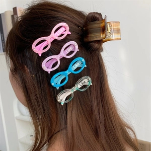 Set of colorful glasses-shaped acetate hair clips and a tortoiseshell claw clip
