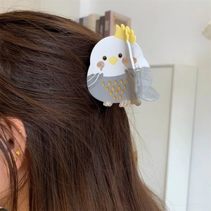 Detail of cockatiel acetate hair claw clip worn on brown hair for a sweet styling