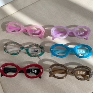 Six-piece set of oval eyewear-shaped acetate hair clips with crystal accents and Like text
