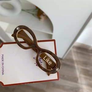 Detail of tortoise shell acetate glasses-shaped hair clip with Like logo and rhinestones