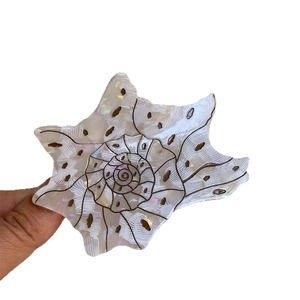 Chic conch-shaped acetate hair claw with white polka dots and pearl finish