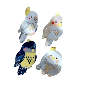 Set of four colorful bird shaped acetate hair claws in various colors for daily hair styling