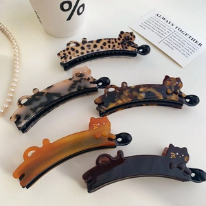 Group of cat-shaped acetate banana hair clips with leopard print and rhinestone details