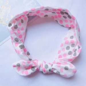 Bandeau bébé en coton à pois roses et gris avec un joli nœud pour nourrissons